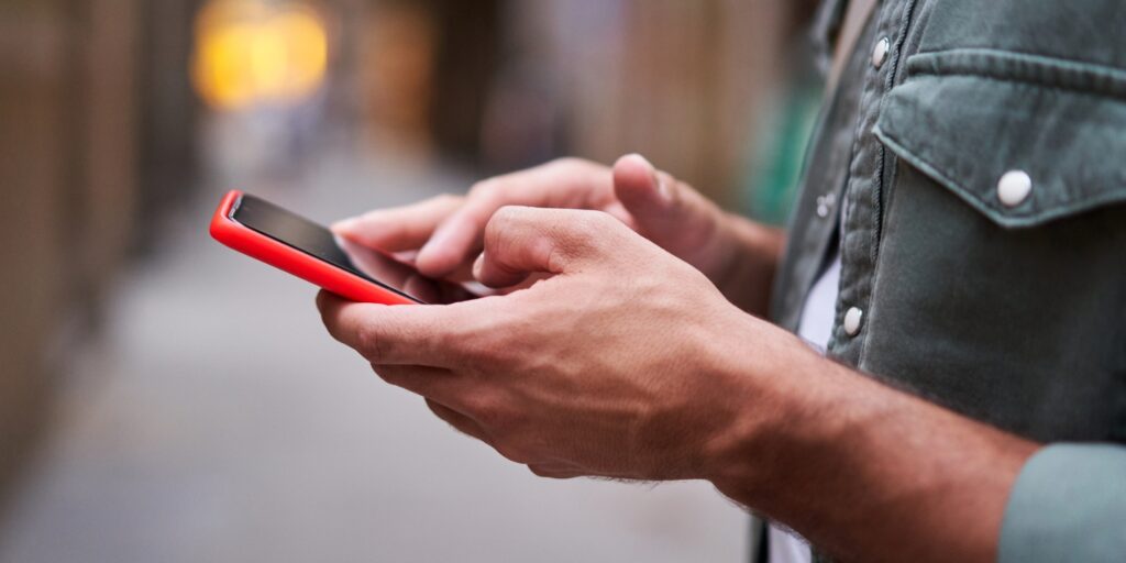 Image of a mans hand holding a phone