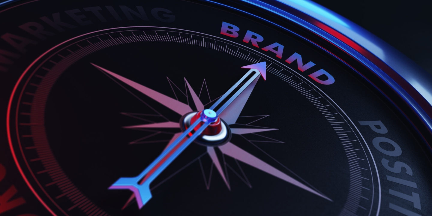 compass with an arrow pointing to the word 'brand'