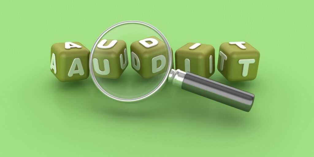 Green dice spelling out the word audit