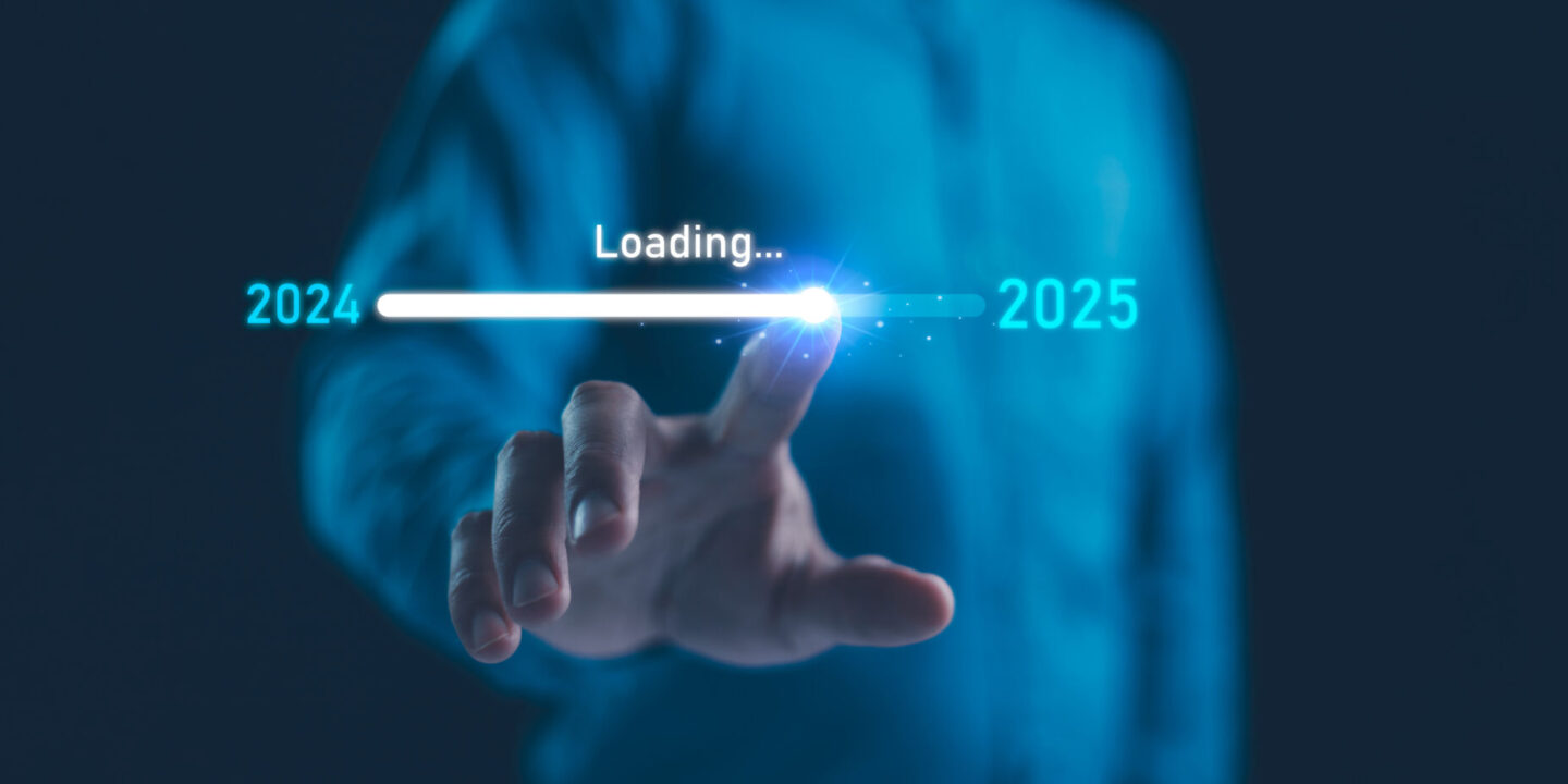 A picture of a man moving a dial from 2024 to 2025